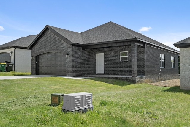7213 Stonehenge Dr, Sherwood, AR 72120 - view of front of house featuring brick siding, concrete driveway, an attached garage, a front yard, and roof with shingles