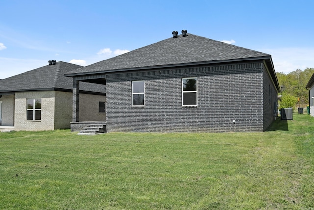 7213 Stonehenge Dr, Sherwood, AR 72120 - rear view of house with brick siding, a shingled roof, and a yard