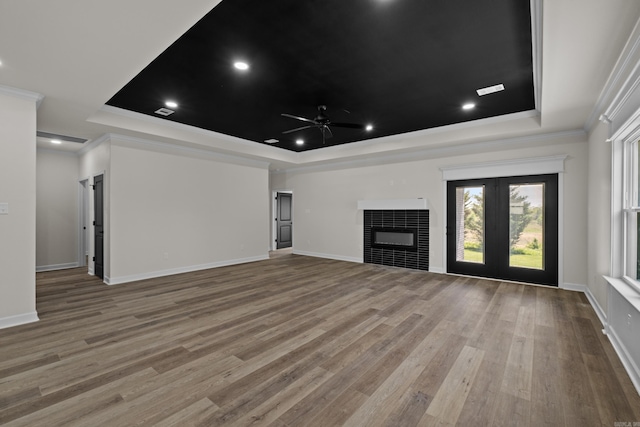7213 Stonehenge Dr, Sherwood, AR 72120 - unfurnished living room with a raised ceiling, ceiling fan, a tile fireplace, crown molding, and wood finished floors