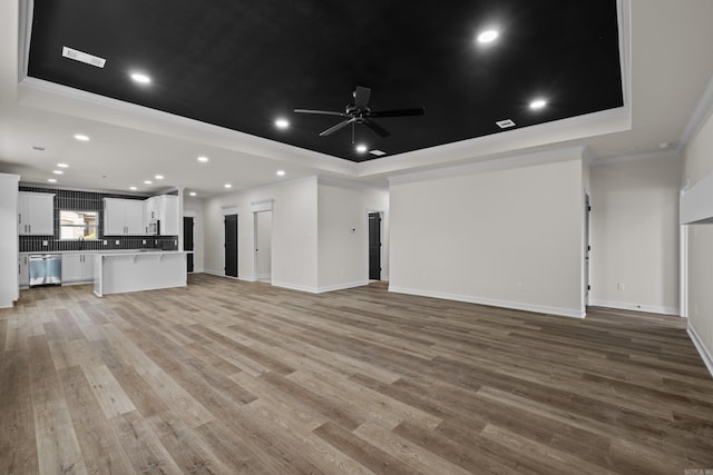 7213 Stonehenge Dr, Sherwood, AR 72120 - unfurnished living room featuring a raised ceiling, ceiling fan, ornamental molding, light wood-type flooring, and recessed lighting