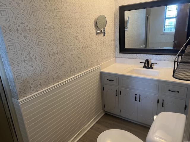11 Laura Ln, Conway, AR 72034 - bathroom with wallpapered walls, a wainscoted wall, vanity, and wood finished floors