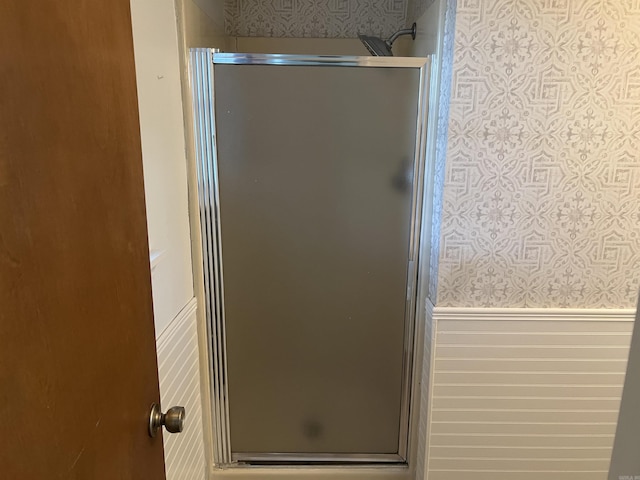 11 Laura Ln, Conway, AR 72034 - bathroom featuring wallpapered walls, a wainscoted wall, and a stall shower