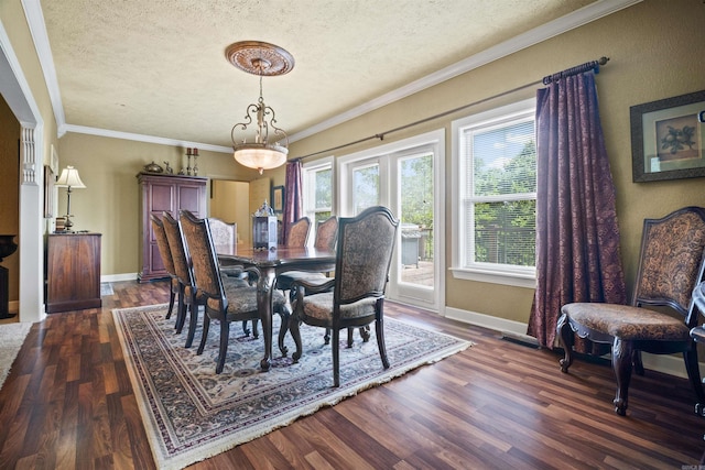 410 E Green St, Morrilton, AR 72110 - dining space featuring a textured ceiling, dark wood finished floors, and crown molding