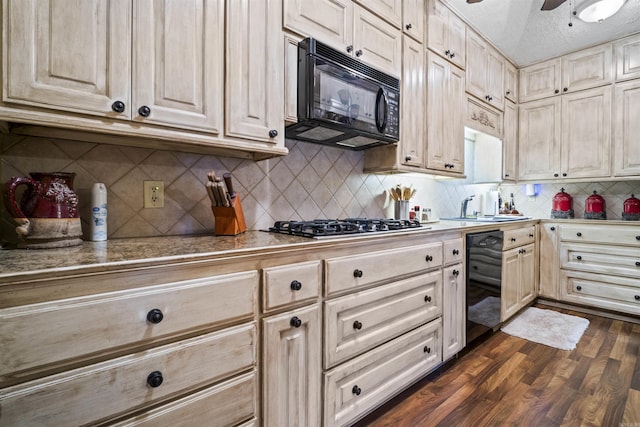410 E Green St, Morrilton, AR 72110 - kitchen with black appliances, dark wood-style flooring, light countertops, backsplash, and a textured ceiling