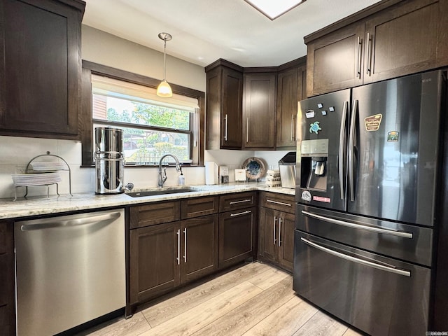 310 Kleinshore Rd Unit C-1, Hot Springs, AR 71913 - kitchen featuring stainless steel appliances, dark brown cabinets, light wood-style floors, light stone countertops, and hanging light fixtures