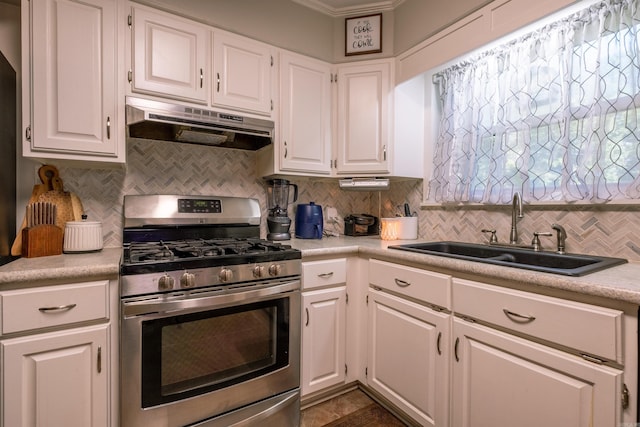 4203 Glenda Ln, Benton, AR 72019 - kitchen with gas stove, under cabinet range hood, light countertops, backsplash, and ornamental molding