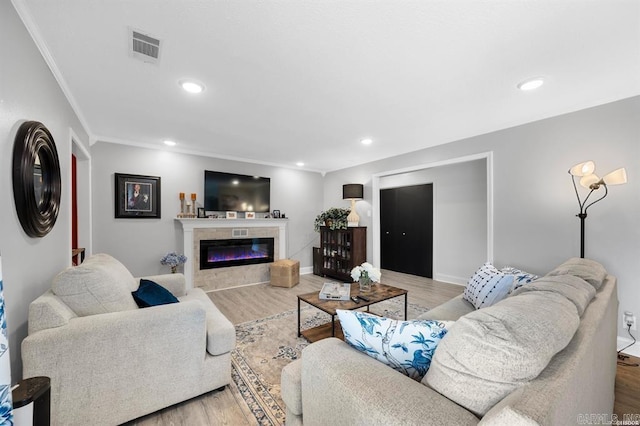 501 Belvedere Unit C-6, Hot Springs, AR 71901 - living room featuring wood finished floors, a glass covered fireplace, recessed lighting, and ornamental molding