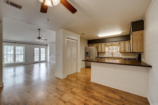 1005 S German Ln, Conway, AR 72034 - kitchen featuring a ceiling fan, stainless steel fridge, dark countertops, and stove