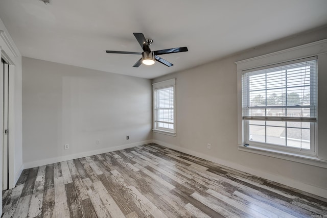 1005 S German Ln, Conway, AR 72034 - unfurnished bedroom with wood finished floors and ceiling fan