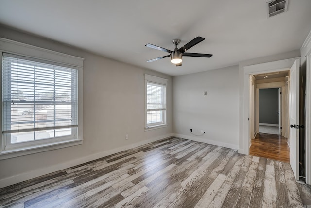 1005 S German Ln, Conway, AR 72034 - unfurnished bedroom with wood finished floors and ceiling fan
