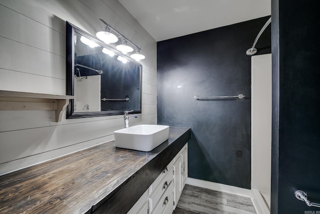 1005 S German Ln, Conway, AR 72034 - bathroom featuring vanity, wood finished floors, and a shower