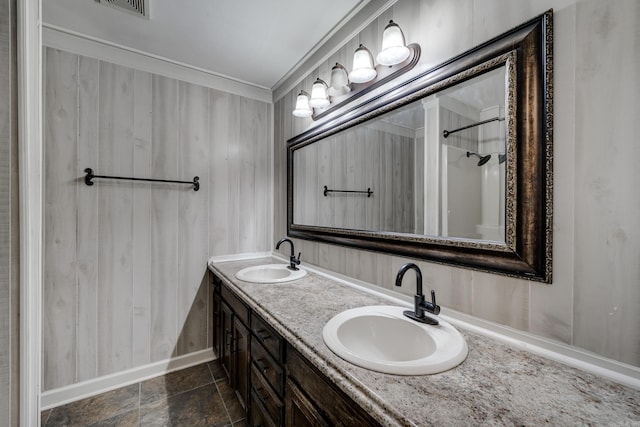 1005 S German Ln, Conway, AR 72034 - bathroom featuring double vanity, a shower, and crown molding
