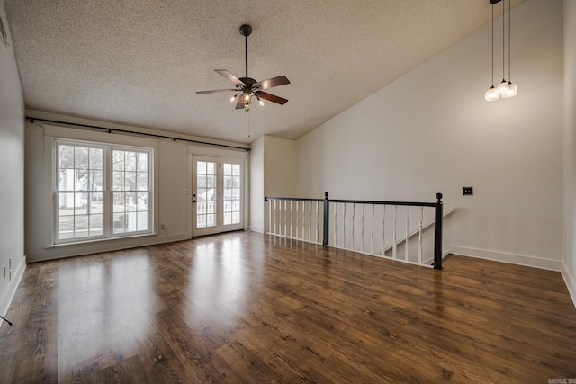 1005 S German Ln, Conway, AR 72034 - empty room with lofted ceiling, a textured ceiling, ceiling fan, and wood finished floors
