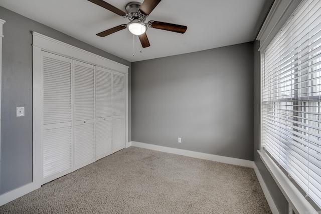 1005 S German Ln, Conway, AR 72034 - unfurnished bedroom featuring carpet floors, a closet, and a ceiling fan