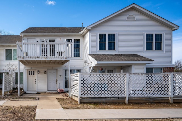1005 S German Ln, Conway, AR 72034 - view of front of property with a shingled roof and a balcony