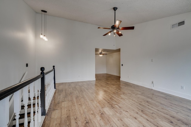 1005 S German Ln, Conway, AR 72034 - spare room with a ceiling fan, light wood-style floors, and a textured ceiling