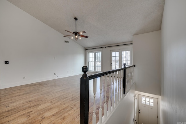 1005 S German Ln, Conway, AR 72034 - stairs featuring a textured ceiling, a ceiling fan, wood finished floors, and lofted ceiling