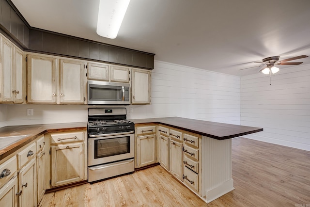 1005 S German Ln, Conway, AR 72034 - kitchen with appliances with stainless steel finishes, a peninsula, light wood-style flooring, a ceiling fan, and light brown cabinets