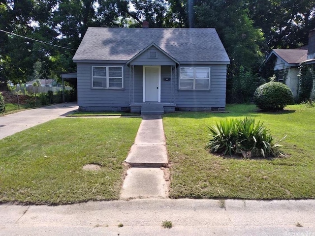 bungalow with a chimney, a front yard, a shingled roof, and crawl space