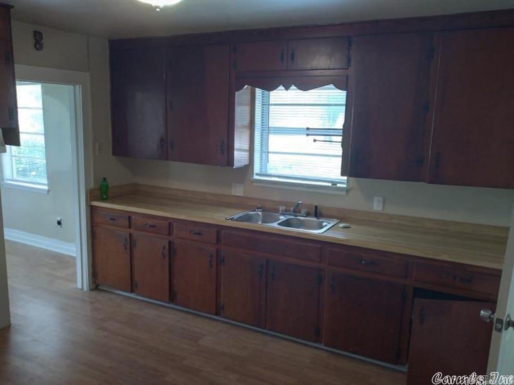 kitchen featuring light countertops, healthy amount of natural light, and wood finished floors