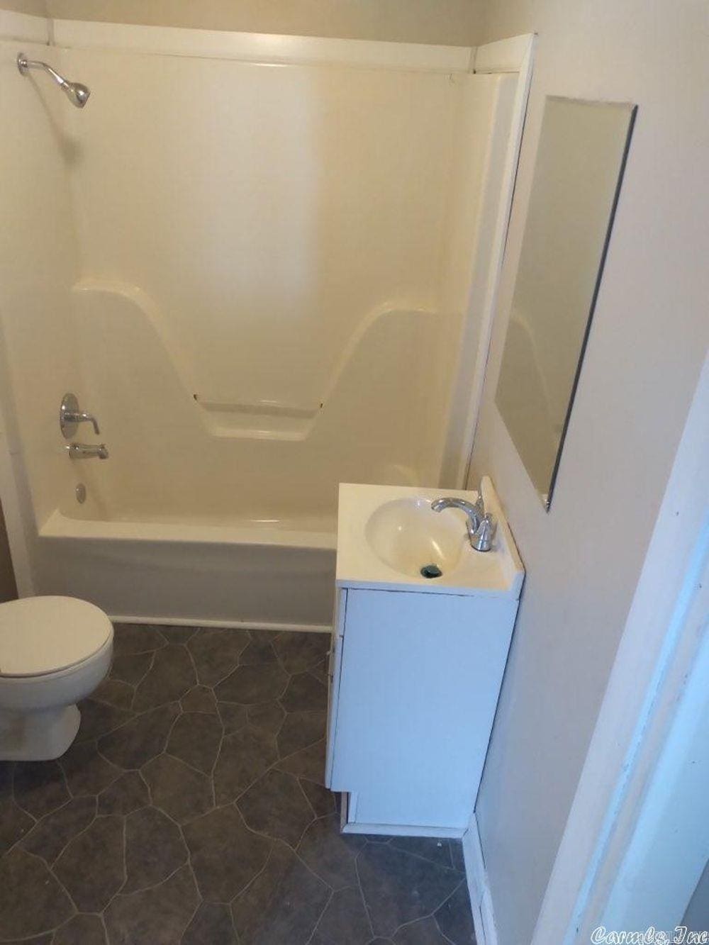 bathroom with vanity and shower / washtub combination