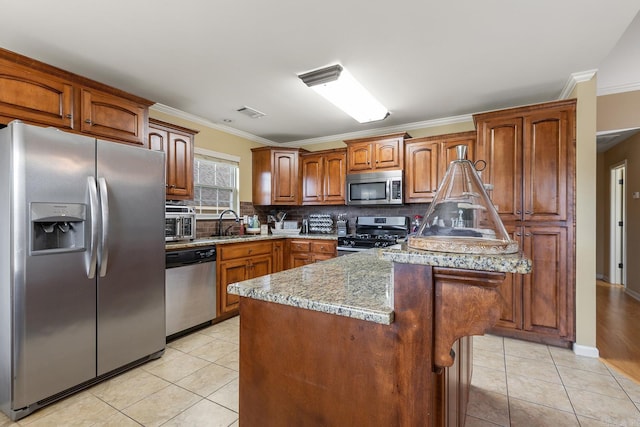 2104 Magna Carta Ln, Bryant, AR 72022 - kitchen featuring appliances with stainless steel finishes, light tile patterned flooring, tasteful backsplash, and ornamental molding