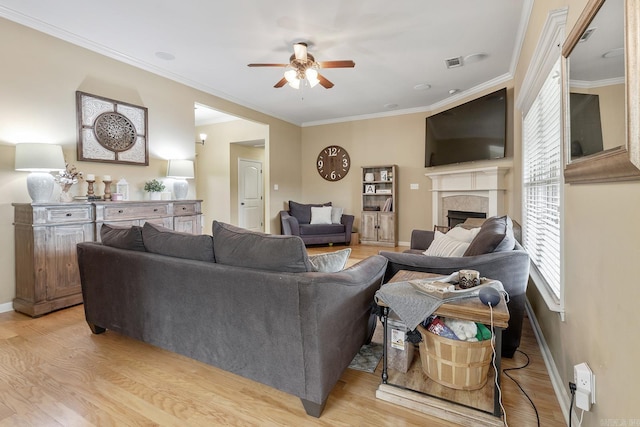2104 Magna Carta Ln, Bryant, AR 72022 - living room with ceiling fan, light wood-type flooring, a fireplace, and crown molding