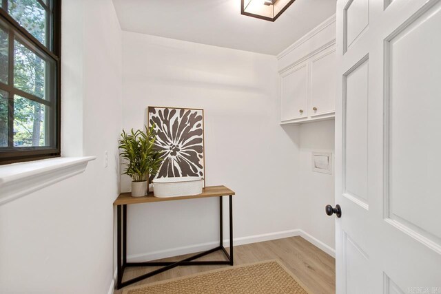 2616 Old Forge Dr, Little Rock, AR 72227 - laundry room featuring light wood finished floors and cabinet space