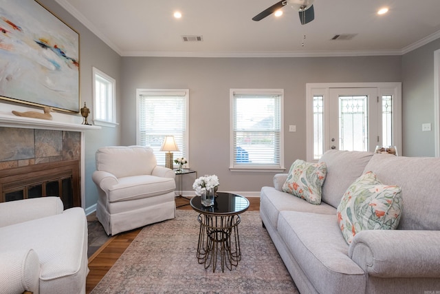 2222 N University, Little Rock, AR 72207 - living room featuring wood finished floors, ornamental molding, a tiled fireplace, ceiling fan, and recessed lighting