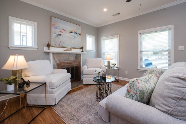 2222 N University, Little Rock, AR 72207 - living area with wood finished floors, ornamental molding, a tile fireplace, recessed lighting, and a ceiling fan