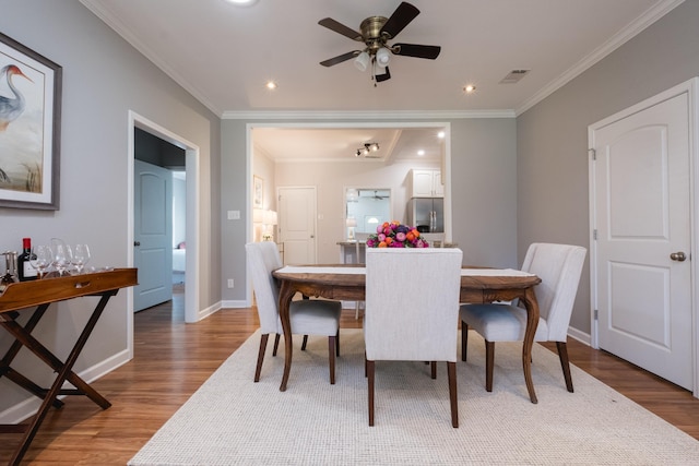 2222 N University, Little Rock, AR 72207 - dining space with wood finished floors, crown molding, a ceiling fan, and recessed lighting