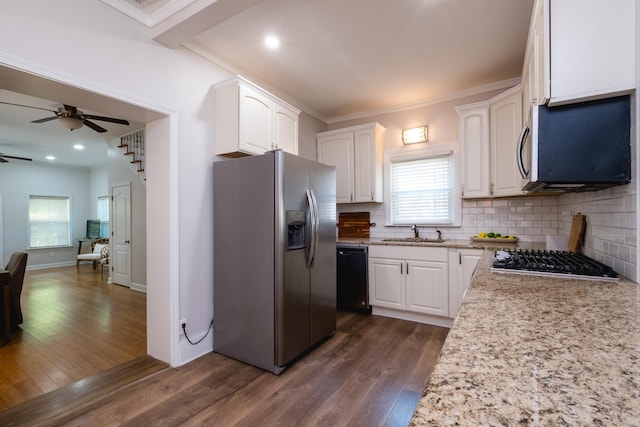 2222 N University, Little Rock, AR 72207 - kitchen featuring stainless steel appliances, a ceiling fan, dark wood finished floors, white cabinets, and backsplash