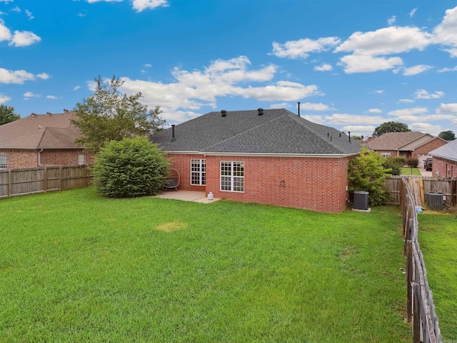 1700 Hosta, Conway, AR 72034 - back of house with brick siding, a shingled roof, a patio area, and a fenced backyard