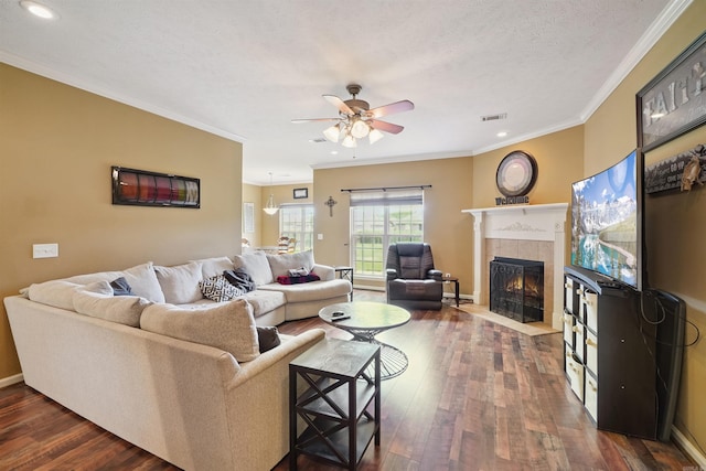 1700 Hosta, Conway, AR 72034 - living area featuring a tiled fireplace, a ceiling fan, crown molding, dark wood finished floors, and recessed lighting