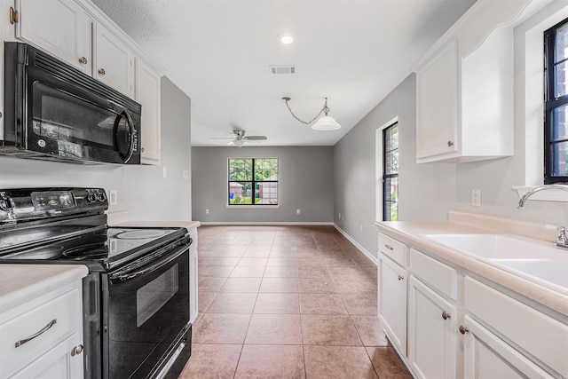1465 Pyramid Dr, Conway, AR 72034 - kitchen featuring black appliances, light countertops, and white cabinets