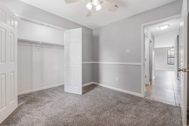 1465 Pyramid Dr, Conway, AR 72034 - unfurnished bedroom with carpet flooring, a closet, ceiling fan, and tile patterned floors