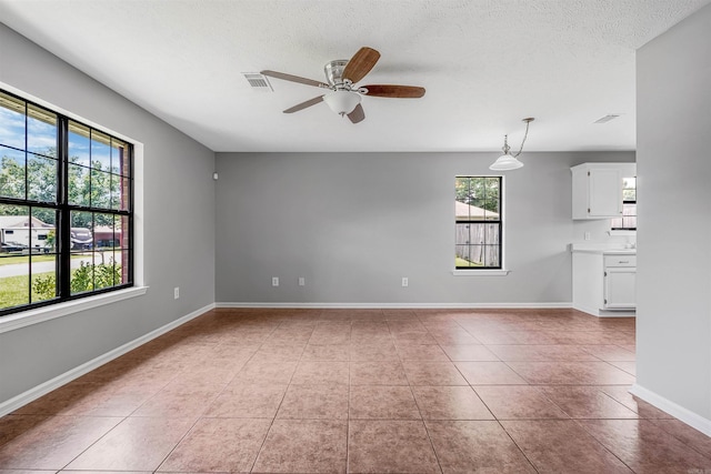 1465 Pyramid Dr, Conway, AR 72034 - unfurnished room with a ceiling fan, light tile patterned floors, and a textured ceiling