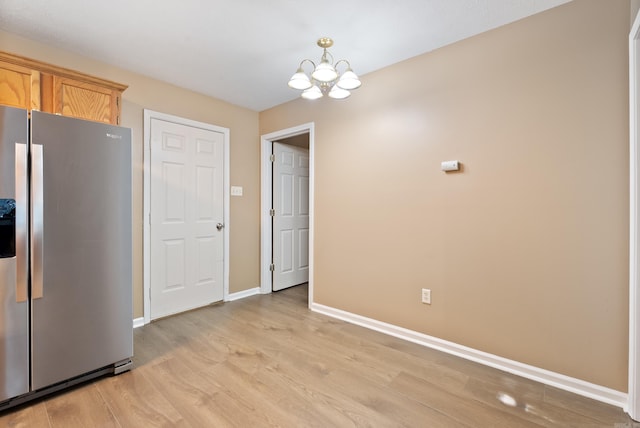 1410 Pyramid Dr, Conway, AR 72032 - kitchen with stainless steel fridge, a chandelier, and light wood-style flooring