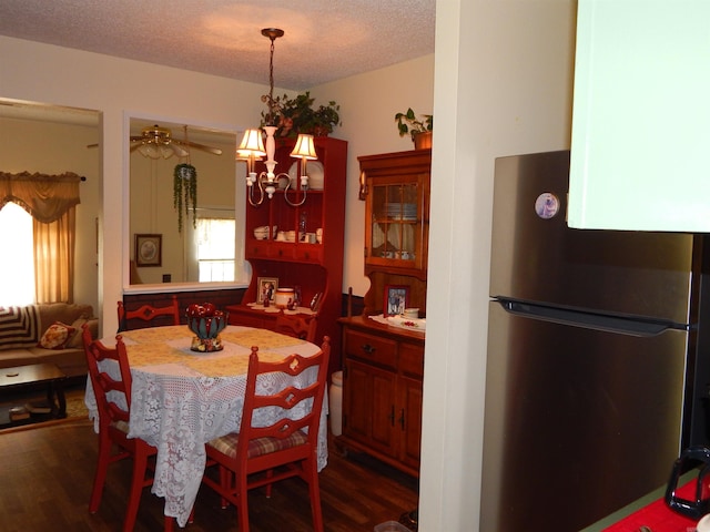 155 N Ridge Rd, Heber Springs, AR 72543 - dining area with dark wood-style floors, a chandelier, and a textured ceiling