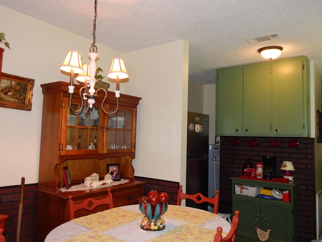 155 N Ridge Rd, Heber Springs, AR 72543 - dining area featuring a chandelier, a textured ceiling, and a wainscoted wall