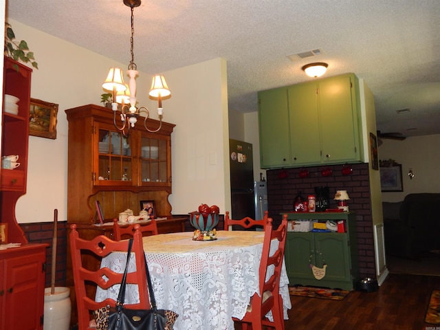 155 N Ridge Rd, Heber Springs, AR 72543 - dining room with a chandelier, dark wood finished floors, and a textured ceiling
