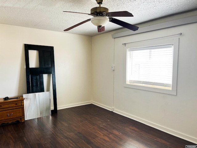 unfurnished room with a textured ceiling, ceiling fan, and dark hardwood / wood-style floors