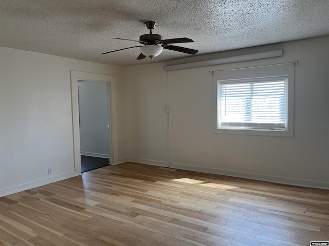 unfurnished room featuring a textured ceiling, ceiling fan, and light hardwood / wood-style flooring