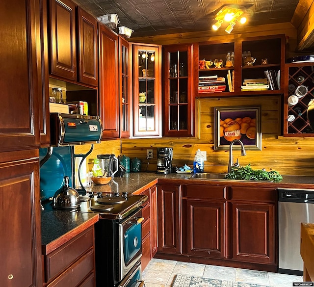 kitchen with stainless steel appliances, light tile flooring, and sink