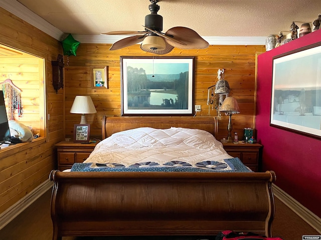 bedroom featuring ceiling fan, wooden walls, and crown molding