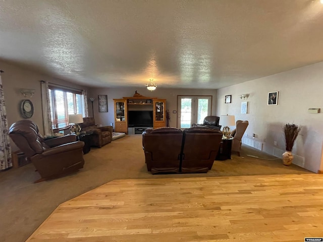 living room with light carpet and a textured ceiling