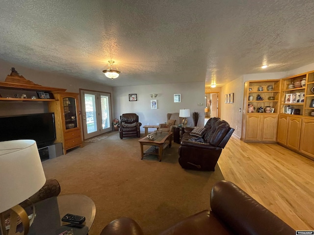 carpeted living room with built in features and a textured ceiling