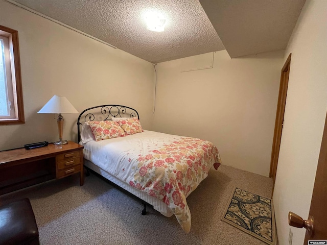 carpeted bedroom featuring a textured ceiling