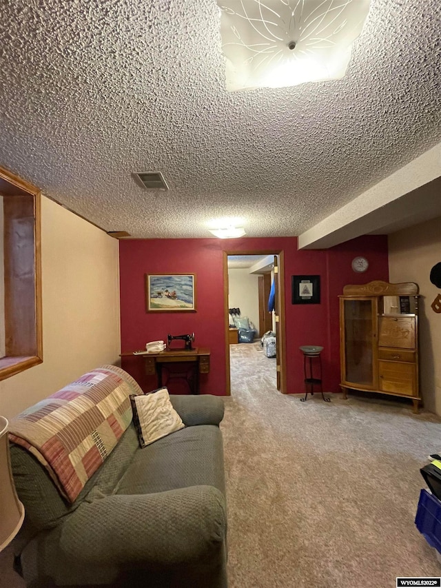 bedroom with light carpet and a textured ceiling