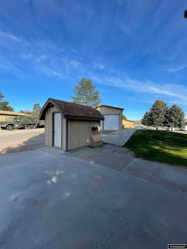 view of property exterior with an outdoor structure and a garage